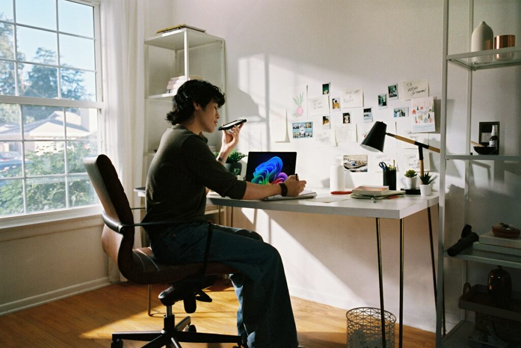 Person comparing a job posting and resume on laptop and phone