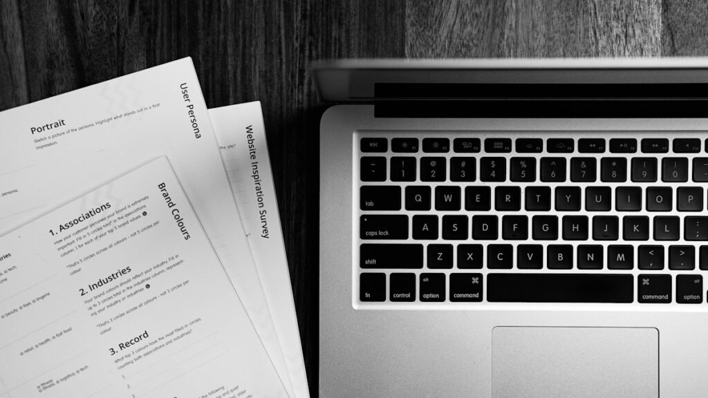 Laptop on a wooden desk used to run an ATS resume score check