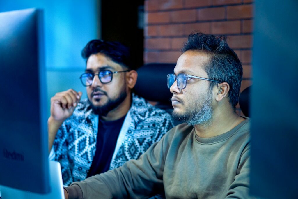 Two people reviewing resume results on a computer screen