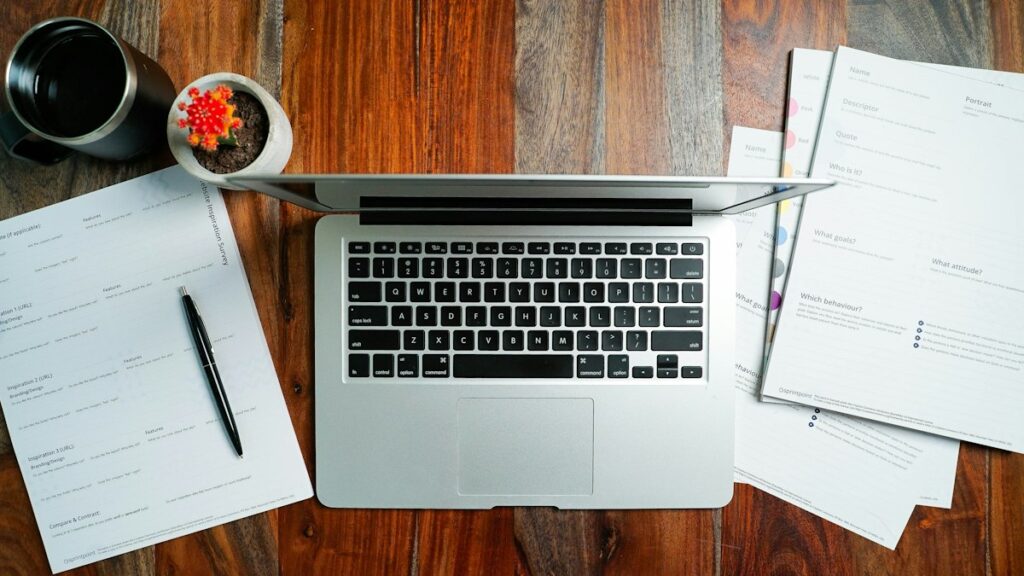 Laptop on a desk showing a CV format for job applications