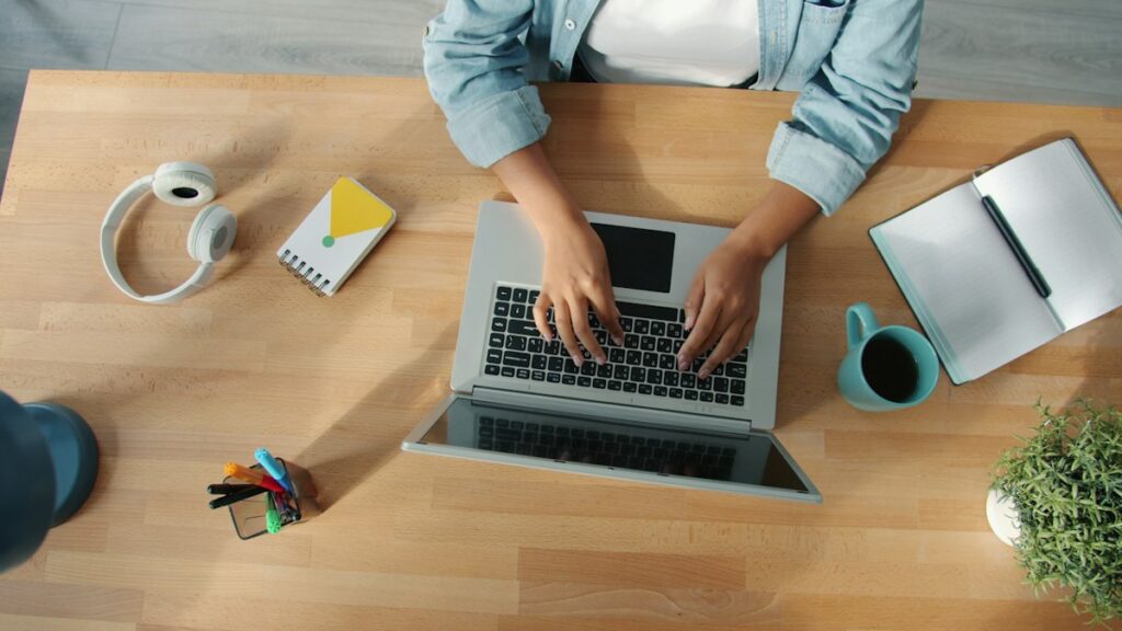 Job seeker concentrating on resume formatting at a wooden desk